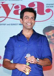 Prithviraj Sukumaran holding a mic, wearing a blue shirt